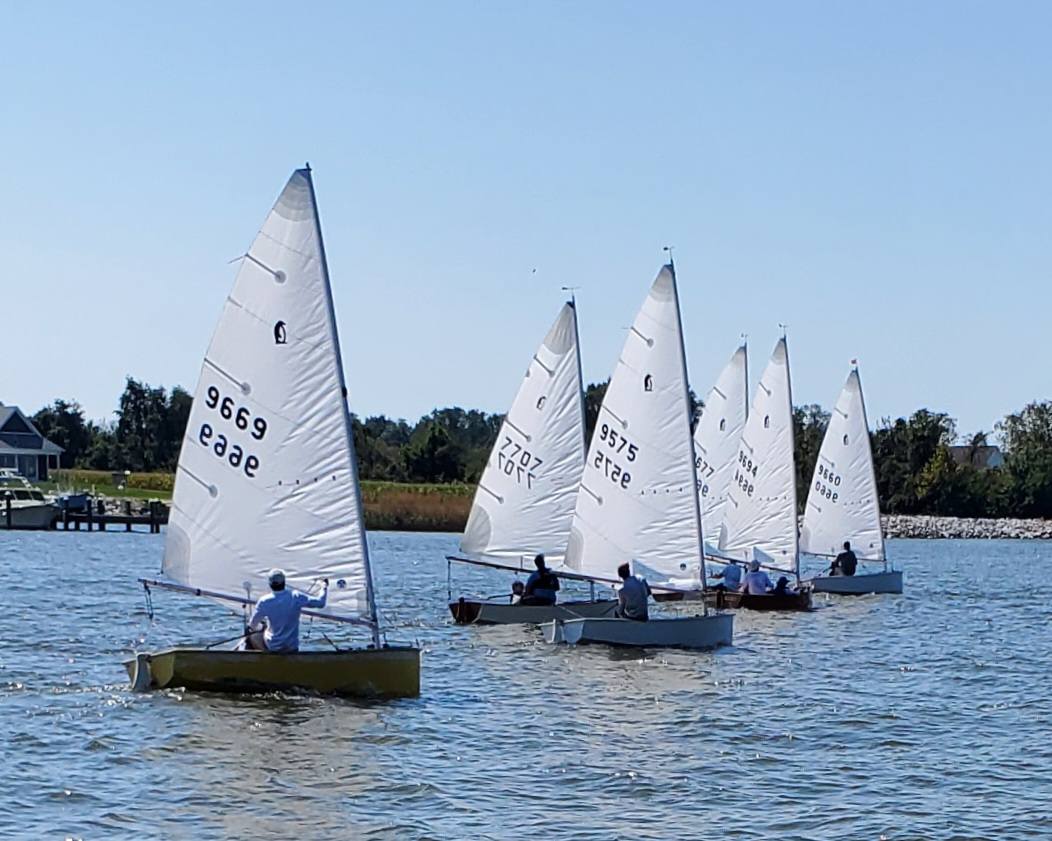 A group of sailboats on a lake AI-generated content may be incorrect.