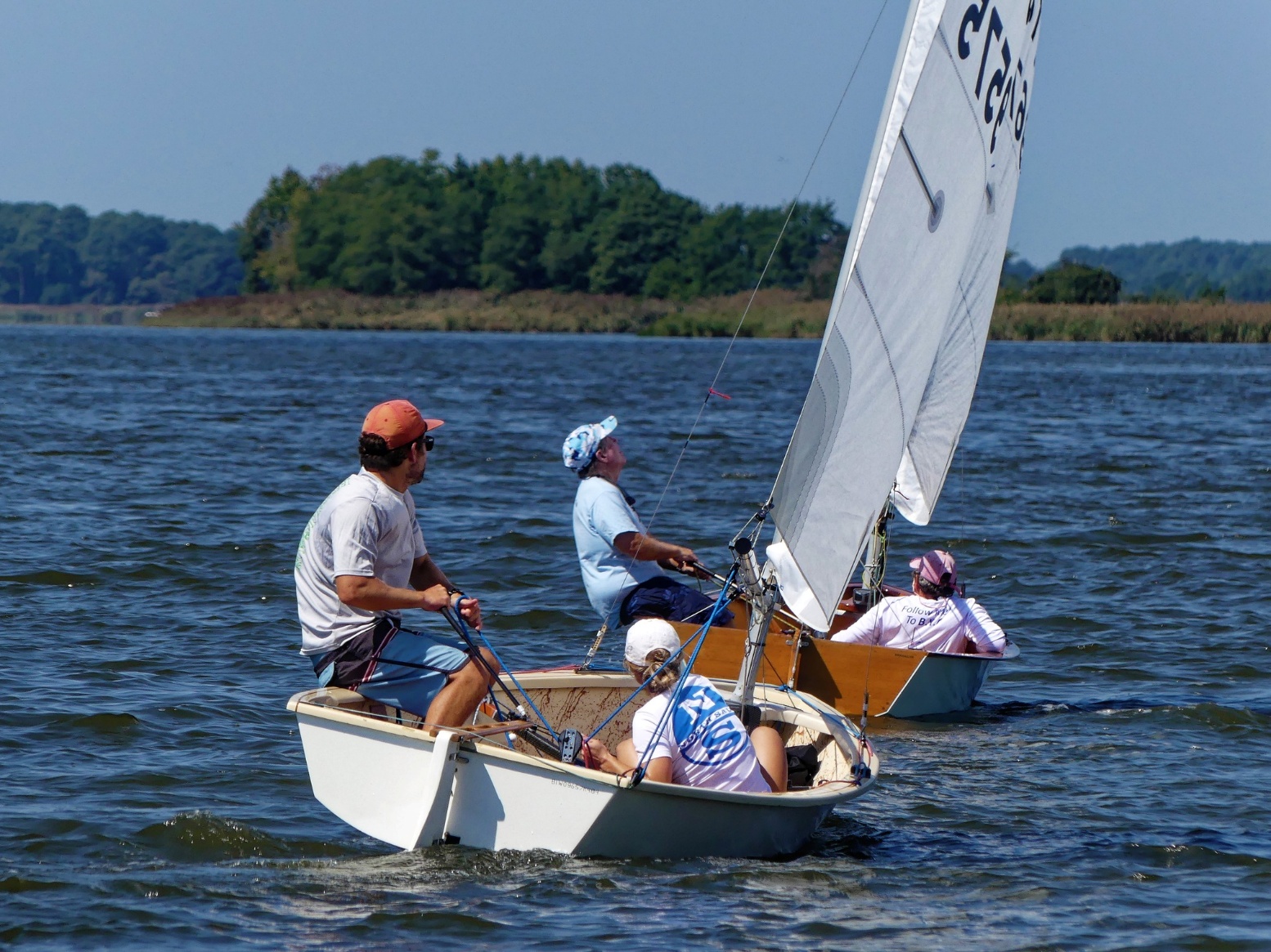 A group of people sailing on a lake AI-generated content may be incorrect.