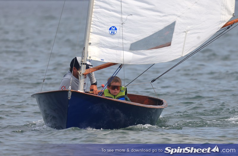 Junior crew aboard a dark blue Penguin